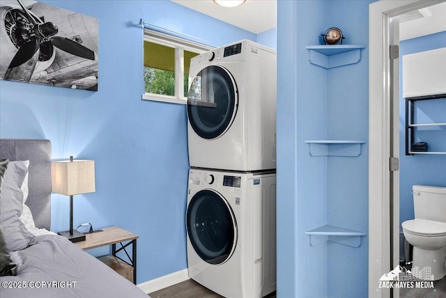 4116 W 88th Ave, Anchorage, AK 99502 - laundry area with stacked washer and clothes dryer and wood finished floors