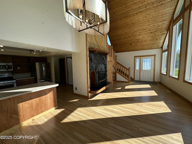 10821 E Valley Crest Dr, Palmer, AK 99645 - unfurnished living room featuring high vaulted ceiling, dark wood finished floors, and a chandelier