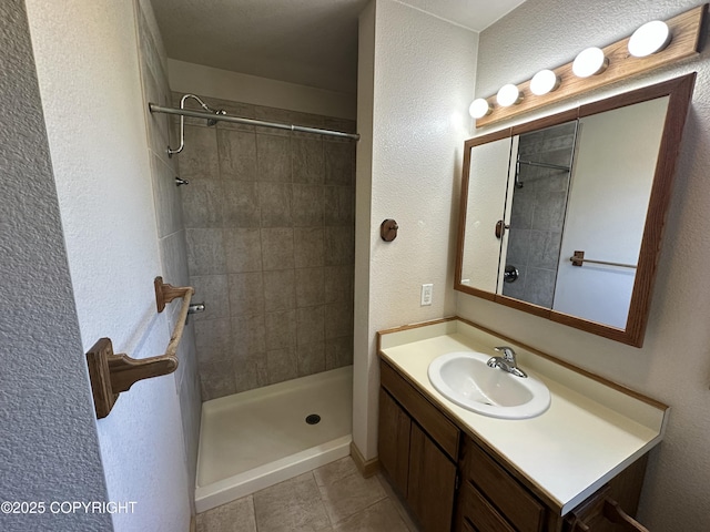 10821 E Valley Crest Dr, Palmer, AK 99645 - full bathroom featuring vanity, a tile shower, tile patterned floors, and a textured wall