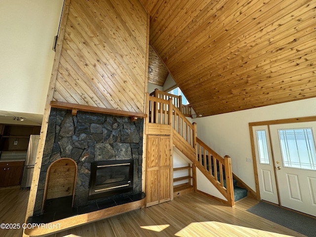 10821 E Valley Crest Dr, Palmer, AK 99645 - unfurnished living room featuring wood finished floors, stairway, high vaulted ceiling, a fireplace, and wood ceiling
