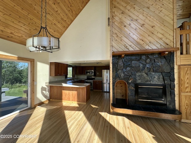 10821 E Valley Crest Dr, Palmer, AK 99645 - unfurnished living room featuring high vaulted ceiling, dark wood-style floors, plenty of natural light, a fireplace, and wood ceiling