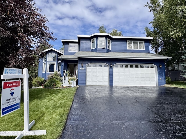 13404 Mainsail Dr, Anchorage, AK 99516 - traditional-style home featuring driveway, a front lawn, and an attached garage