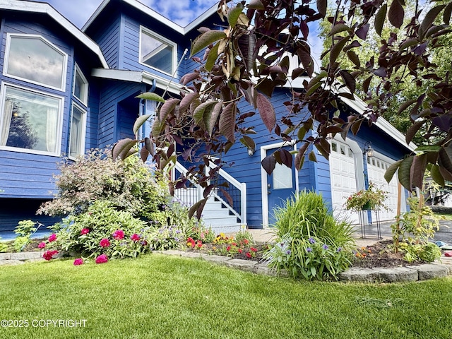 13404 Mainsail Dr, Anchorage, AK 99516 - view of home's exterior featuring a garage and a yard