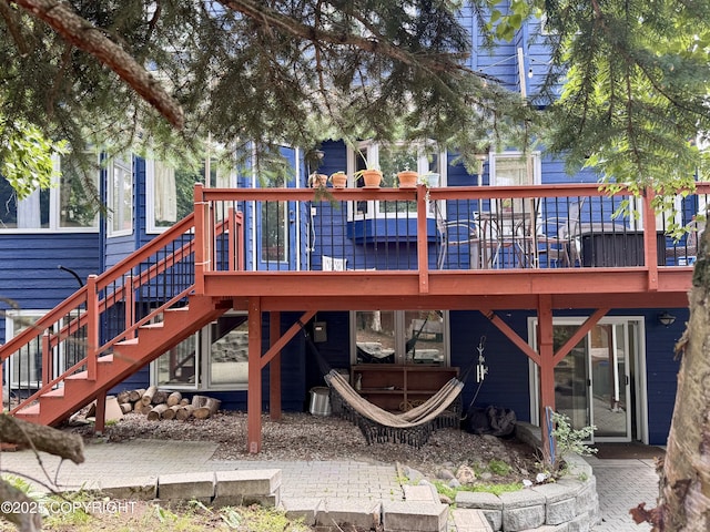 13404 Mainsail Dr, Anchorage, AK 99516 - back of house featuring stairs and a wooden deck