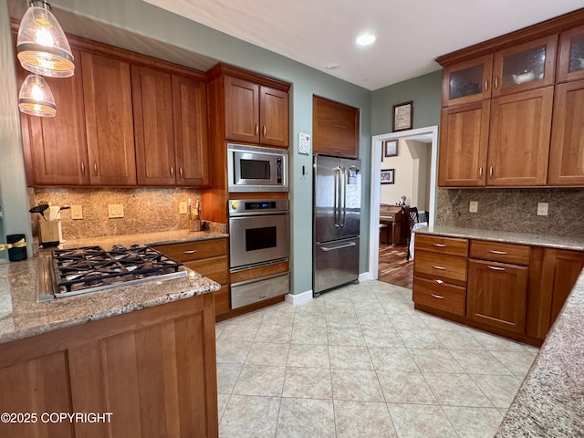 13404 Mainsail Dr, Anchorage, AK 99516 - kitchen featuring stainless steel appliances, a warming drawer, and brown cabinets