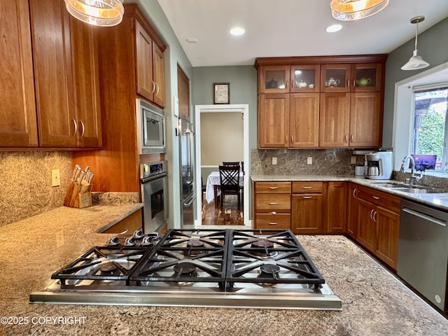 13404 Mainsail Dr, Anchorage, AK 99516 - kitchen with appliances with stainless steel finishes, brown cabinets, decorative light fixtures, glass insert cabinets, and recessed lighting