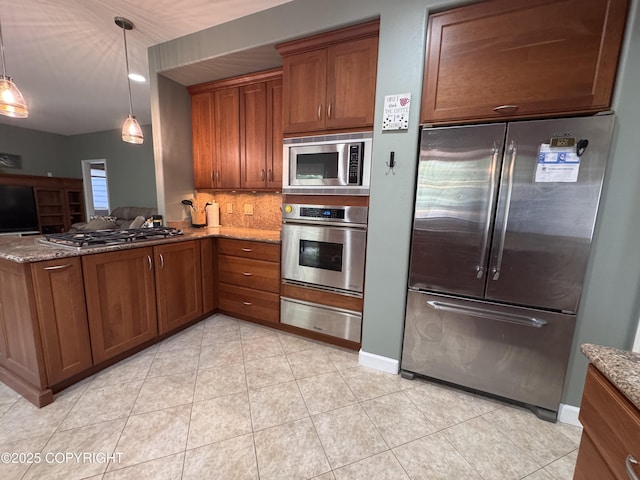 13404 Mainsail Dr, Anchorage, AK 99516 - kitchen with appliances with stainless steel finishes, a warming drawer, brown cabinets, stone countertops, and tasteful backsplash