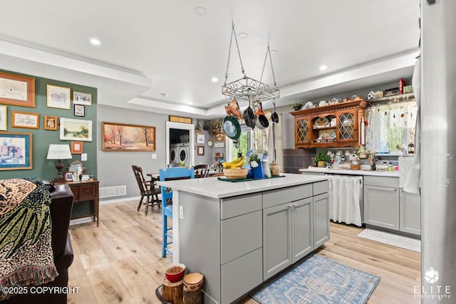 5050 N Gold Mint Dr, Wasilla, AK 99654 - kitchen with stainless steel dishwasher, light wood-style flooring, light countertops, a center island, and recessed lighting