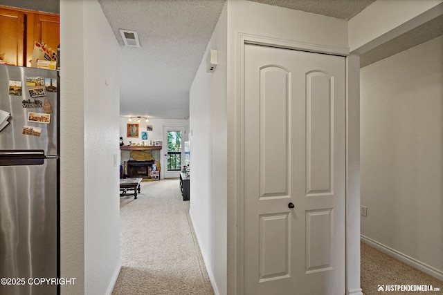 10201 Jamestown Dr # A102, Anchorage, AK 99507 - hallway with carpet flooring and a textured ceiling