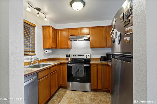10201 Jamestown Dr # A102, Anchorage, AK 99507 - kitchen featuring appliances with stainless steel finishes, under cabinet range hood, and brown cabinetry