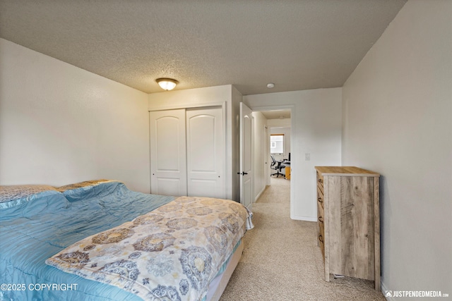 10201 Jamestown Dr # A102, Anchorage, AK 99507 - bedroom featuring light carpet, a closet, and a textured ceiling
