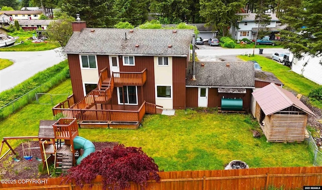 5920 Lund St, Juneau, AK 99801 - back of house featuring a fenced backyard, a chimney, stairway, a playground, and a shingled roof