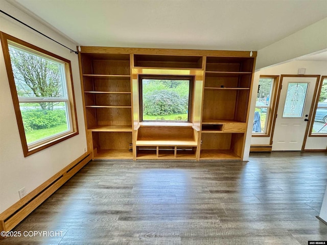 5920 Lund St, Juneau, AK 99801 - unfurnished living room with baseboard heating, built in shelves, and wood finished floors
