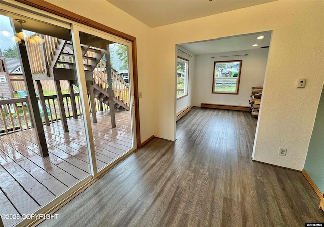 5920 Lund St, Juneau, AK 99801 - doorway with baseboard heating, wood finished floors, and a textured wall