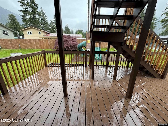 5920 Lund St, Juneau, AK 99801 - deck with a fenced backyard, stairs, and a playground
