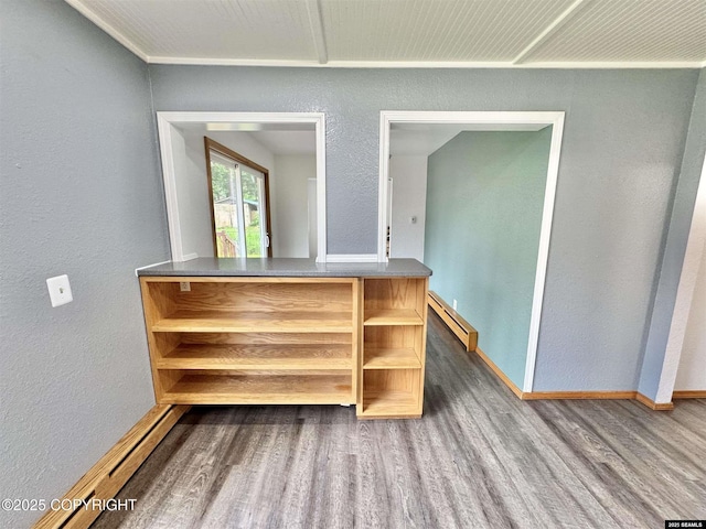 5920 Lund St, Juneau, AK 99801 - detailed view of a baseboard heating unit, wood finished floors, and a textured wall