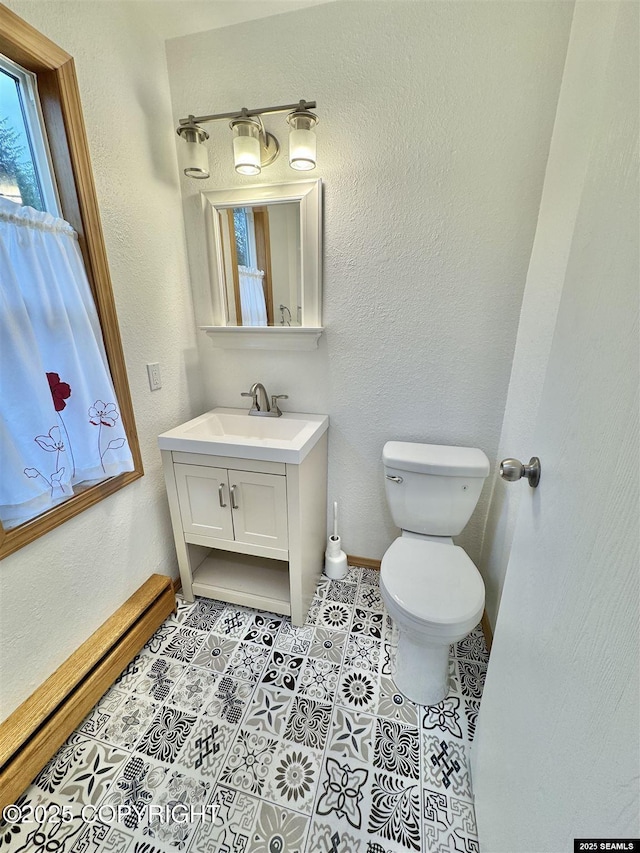 5920 Lund St, Juneau, AK 99801 - bathroom featuring vanity, tile patterned floors, and a baseboard heating unit