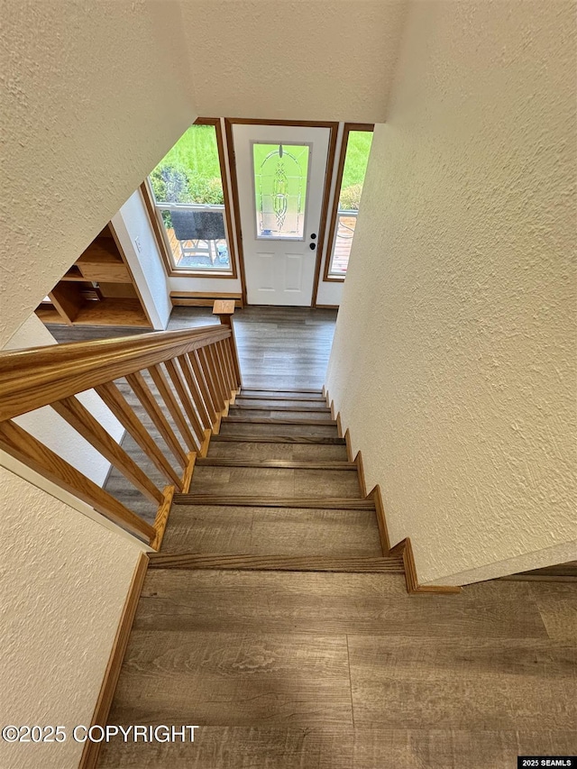 5920 Lund St, Juneau, AK 99801 - staircase featuring a textured wall, hardwood / wood-style floors, a textured ceiling, and lofted ceiling