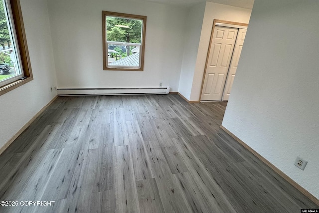 5920 Lund St, Juneau, AK 99801 - empty room featuring a baseboard heating unit and wood finished floors
