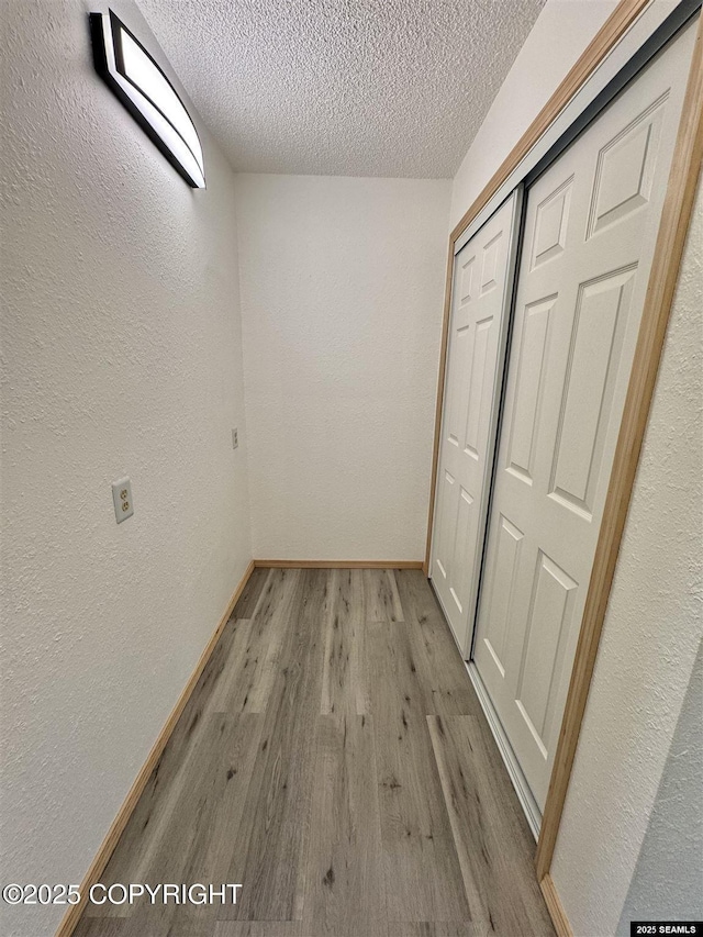 5920 Lund St, Juneau, AK 99801 - hallway with a textured wall, wood finished floors, and a textured ceiling