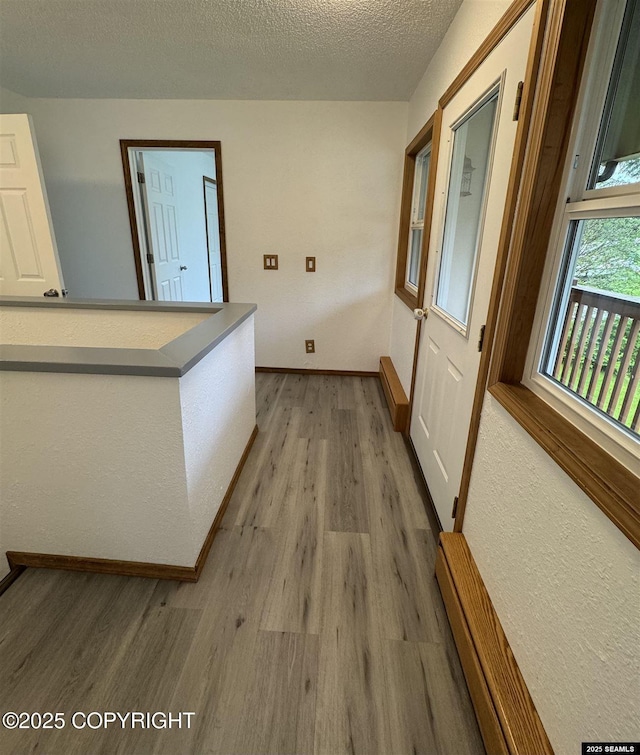 5920 Lund St, Juneau, AK 99801 - hall featuring light wood-type flooring and a textured ceiling