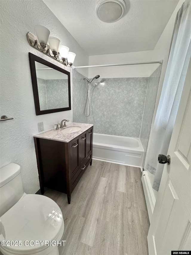 5920 Lund St, Juneau, AK 99801 - bathroom featuring wood finished floors, vanity, a textured ceiling, a textured wall, and shower / bathtub combination with curtain