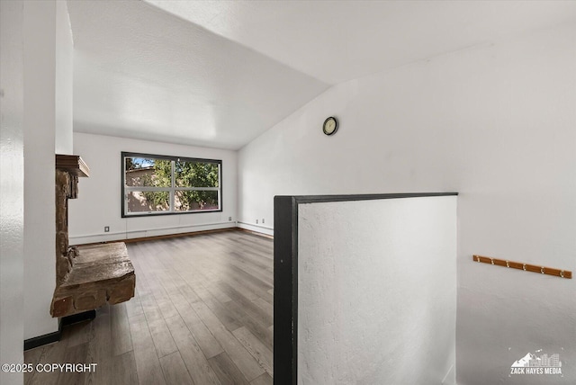 3215 Eastgate Pl # 301, Anchorage, AK 99504 - unfurnished living room featuring vaulted ceiling and wood finished floors