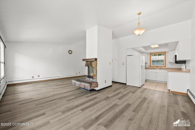 3215 Eastgate Pl # 301, Anchorage, AK 99504 - unfurnished living room featuring light wood-style flooring and a stone fireplace