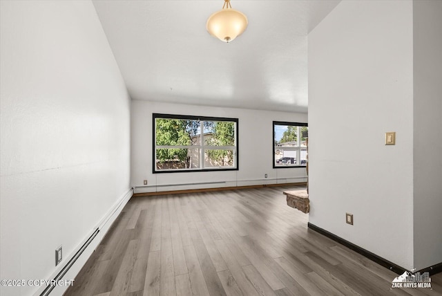 3215 Eastgate Pl # 301, Anchorage, AK 99504 - unfurnished room with a baseboard heating unit, wood finished floors, and baseboard heating