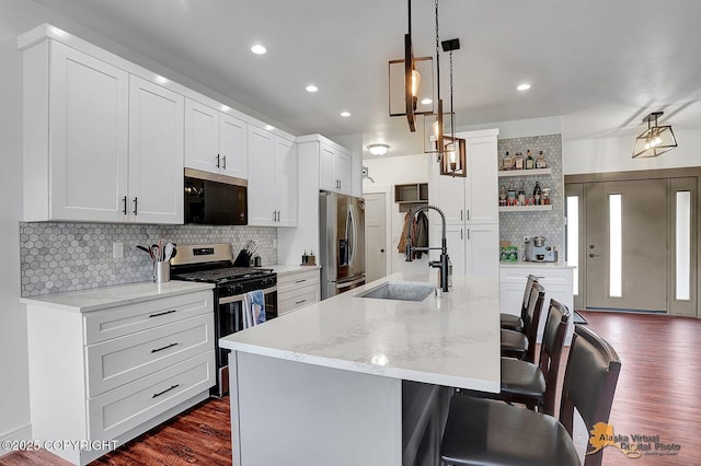 4576 S Gon Fishin Dr, Wasilla, AK 99623 - kitchen featuring stainless steel appliances, open shelves, a breakfast bar, tasteful backsplash, and dark wood-type flooring