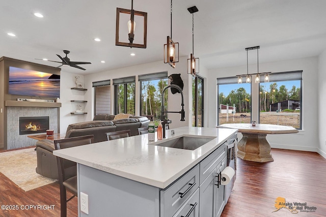 4576 S Gon Fishin Dr, Wasilla, AK 99623 - kitchen with ceiling fan, dark wood-style floors, recessed lighting, decorative light fixtures, and a center island with sink