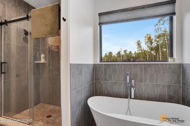 4576 S Gon Fishin Dr, Wasilla, AK 99623 - bathroom with a freestanding tub, a stall shower, and tile walls