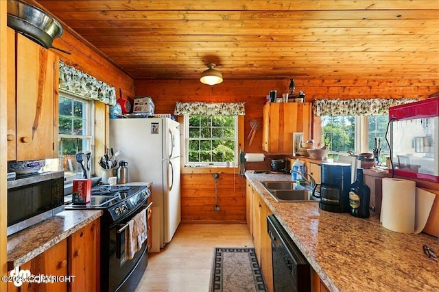 21033 Sterling Hwy, Ninilchik, AK 99639 - kitchen with black appliances, plenty of natural light, light wood-style flooring, wooden ceiling, and brown cabinetry