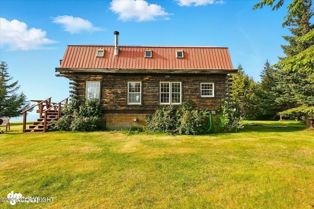 21033 Sterling Hwy, Ninilchik, AK 99639 - view of home's exterior featuring a yard, log exterior, and a metal roof