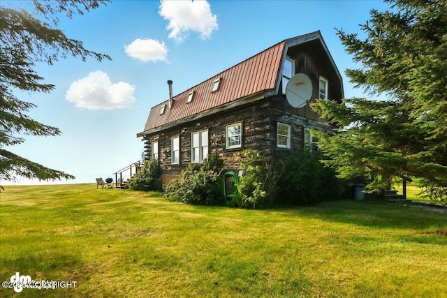 21033 Sterling Hwy, Ninilchik, AK 99639 - view of side of property with a gambrel roof, a yard, a metal roof, and log siding