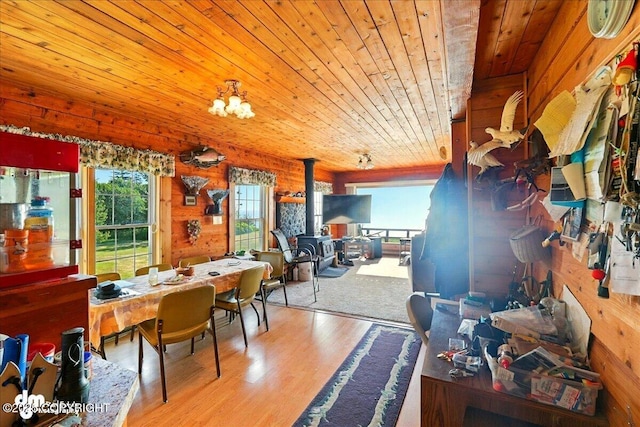 21033 Sterling Hwy, Ninilchik, AK 99639 - dining space featuring wood ceiling, a wood stove, wood finished floors, and wood walls