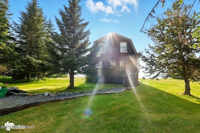 21033 Sterling Hwy, Ninilchik, AK 99639 - view of property exterior featuring a lawn and a gambrel roof