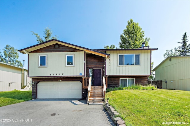 12247 Breckenridge Dr, Eagle River, AK 99577 - bi-level home with asphalt driveway, an attached garage, and a front lawn