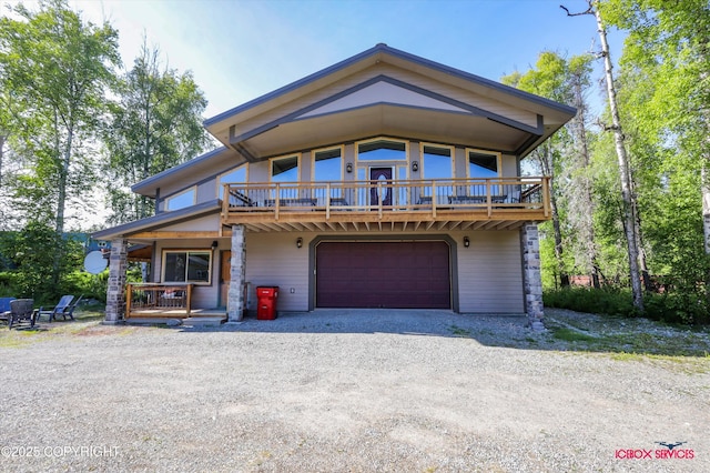 7748 E Gold Bullion Blvd, Palmer, AK 99645 - view of front of house featuring gravel driveway, a garage, and a porch