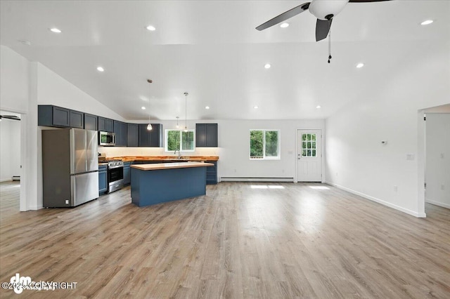 1380 N Cedar Hills Dr, Palmer, AK 99645 - kitchen with stainless steel appliances, a baseboard heating unit, vaulted ceiling, ceiling fan, and a kitchen island
