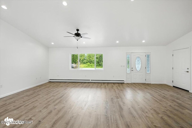 1380 N Cedar Hills Dr, Palmer, AK 99645 - unfurnished living room with ceiling fan, recessed lighting, wood finished floors, and a baseboard heating unit