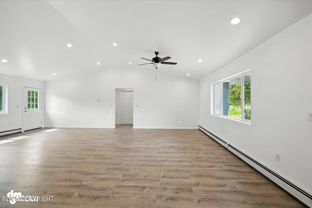 1380 N Cedar Hills Dr, Palmer, AK 99645 - unfurnished living room featuring a baseboard heating unit, healthy amount of natural light, recessed lighting, ceiling fan, and light wood-style flooring
