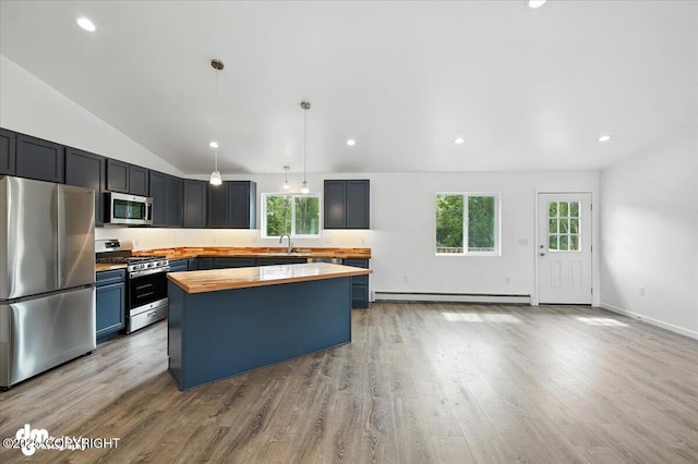 1380 N Cedar Hills Dr, Palmer, AK 99645 - kitchen with stainless steel appliances, wood counters, a baseboard heating unit, healthy amount of natural light, and vaulted ceiling