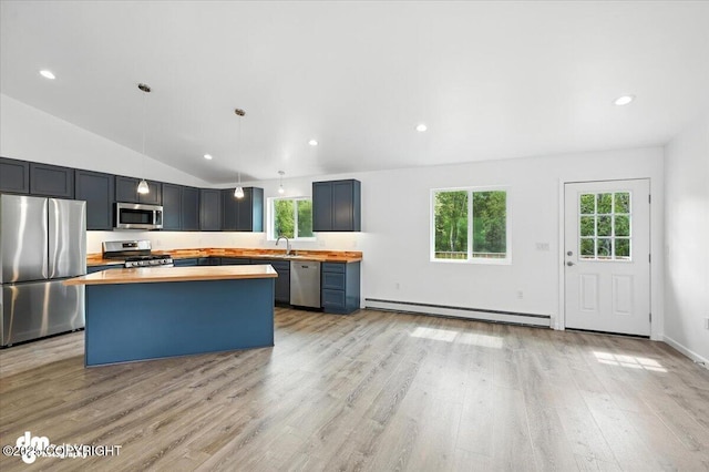 1380 N Cedar Hills Dr, Palmer, AK 99645 - kitchen featuring appliances with stainless steel finishes, butcher block countertops, baseboard heating, plenty of natural light, and vaulted ceiling