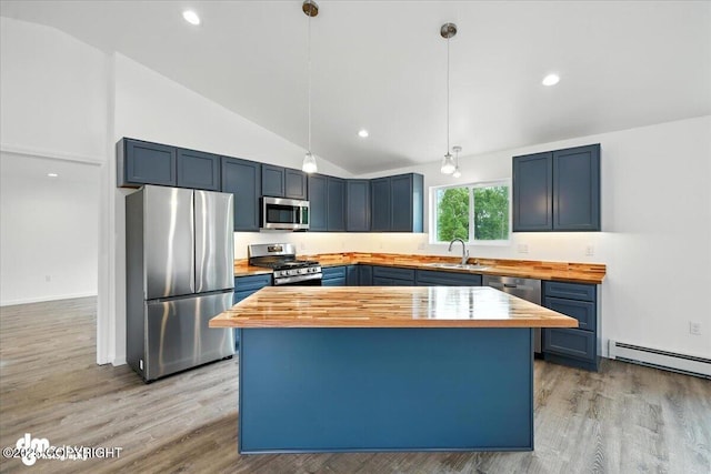 1380 N Cedar Hills Dr, Palmer, AK 99645 - kitchen with appliances with stainless steel finishes, butcher block counters, lofted ceiling, baseboard heating, and blue cabinets