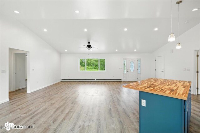 1380 N Cedar Hills Dr, Palmer, AK 99645 - unfurnished living room featuring a ceiling fan, lofted ceiling, light wood-style floors, a baseboard heating unit, and recessed lighting