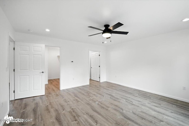 1380 N Cedar Hills Dr, Palmer, AK 99645 - unfurnished bedroom featuring recessed lighting, wood finished floors, a walk in closet, and a ceiling fan