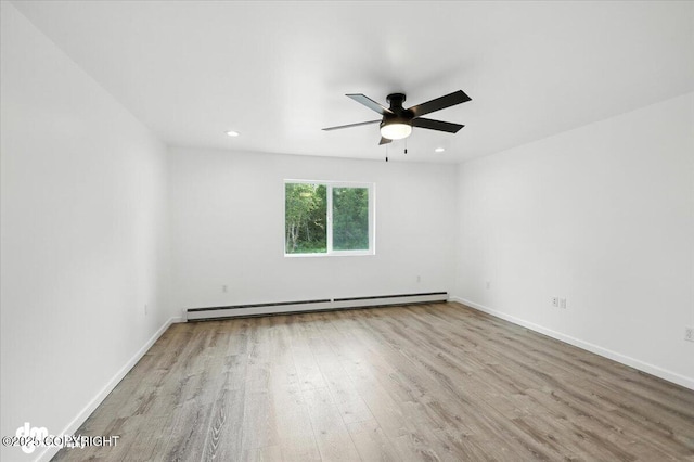 1380 N Cedar Hills Dr, Palmer, AK 99645 - spare room featuring a baseboard heating unit, wood finished floors, a ceiling fan, and recessed lighting