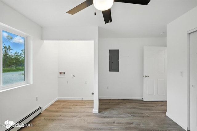 1380 N Cedar Hills Dr, Palmer, AK 99645 - laundry area featuring a baseboard heating unit, electric panel, hookup for a washing machine, ceiling fan, and wood finished floors