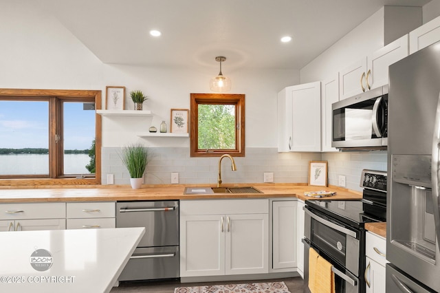 900 W Selina Ln, Wasilla, AK 99654 - kitchen featuring stainless steel appliances, wooden counters, open shelves, backsplash, and recessed lighting